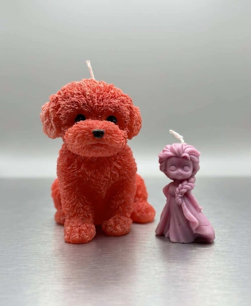 Zwei handgefertigte Figurenkerzen von Barbara: ein orangefarbener Hund und eine kleine violette Prinzessin